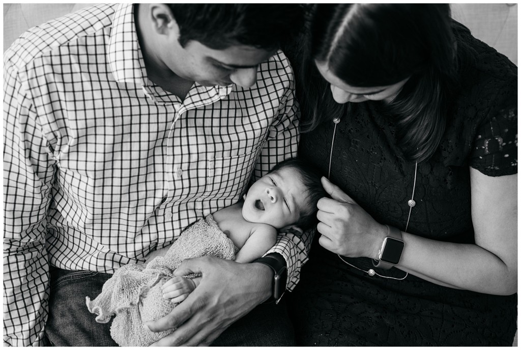 family posing with newborn